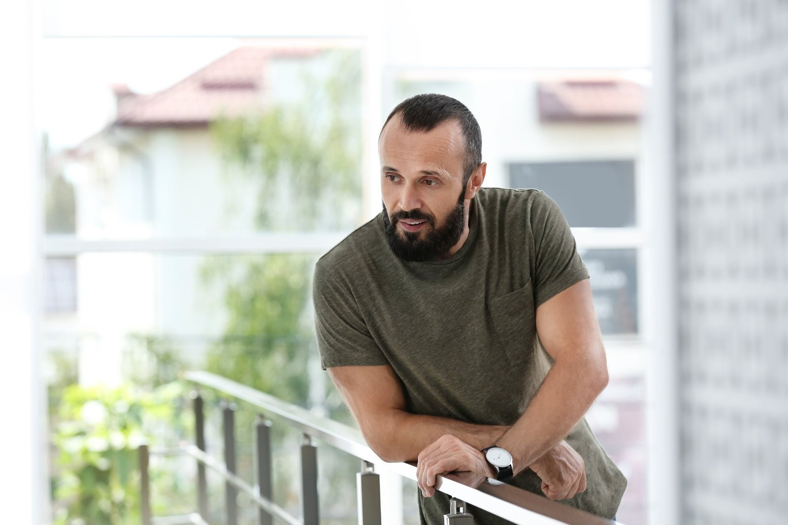 Man at home reflecting on thoughts related to OCD