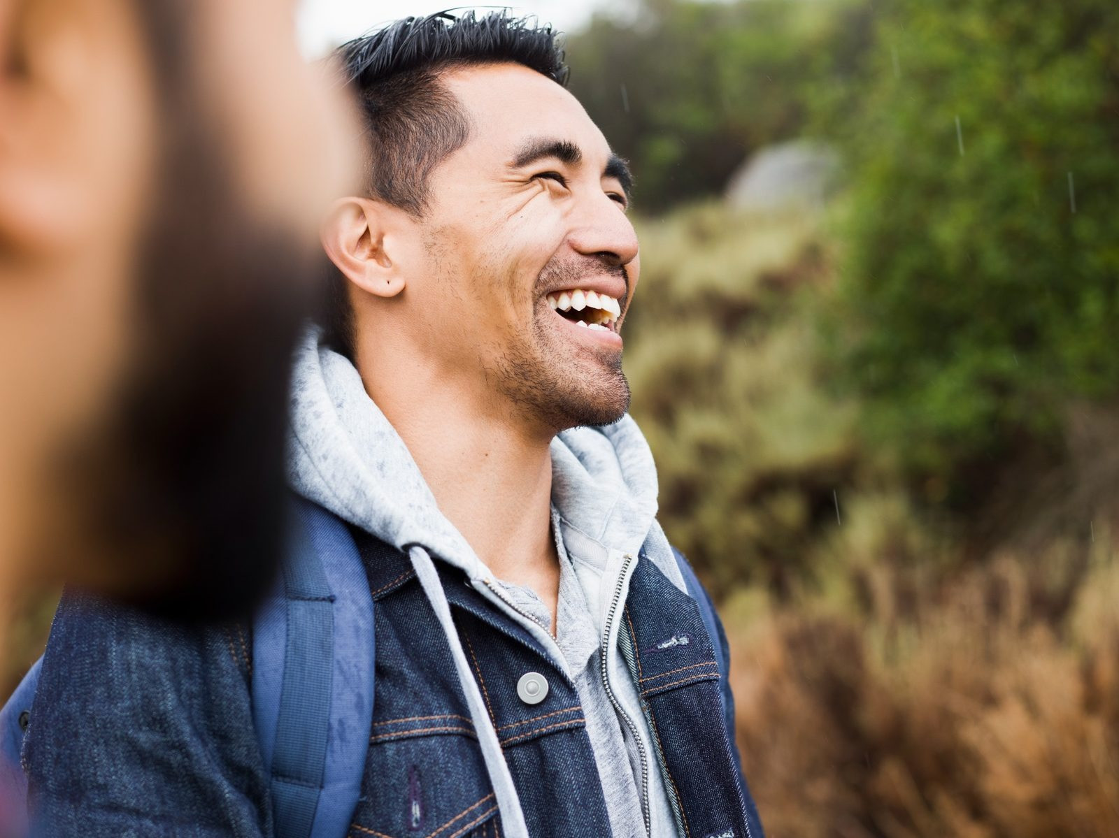 Person smiling outdoors while feeling calm and relaxed