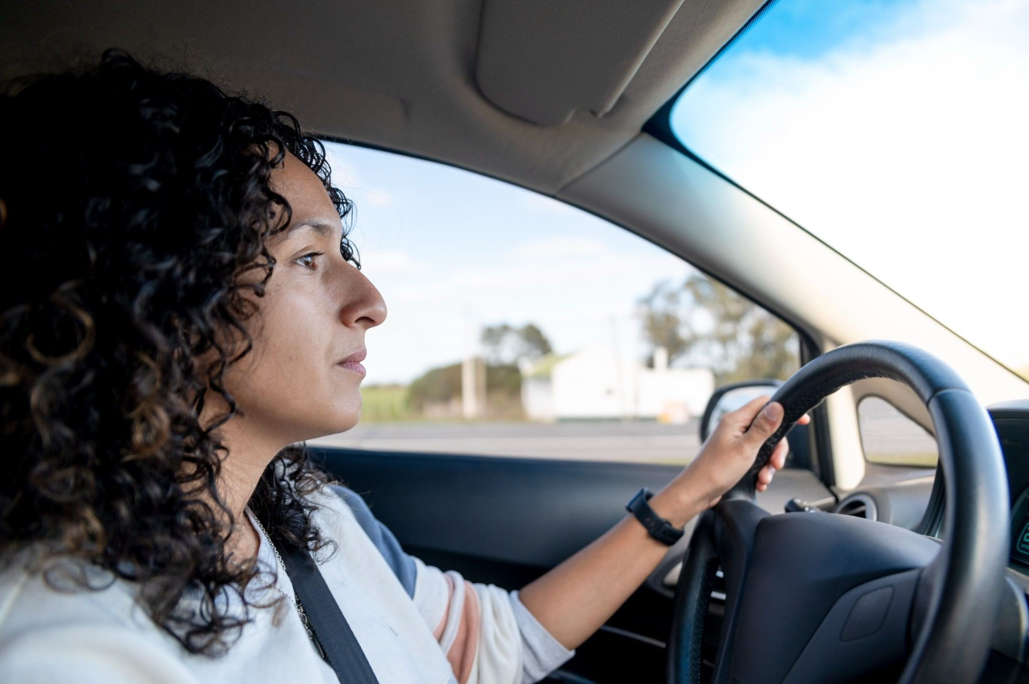 Woman driving a car while looking ahead at the road