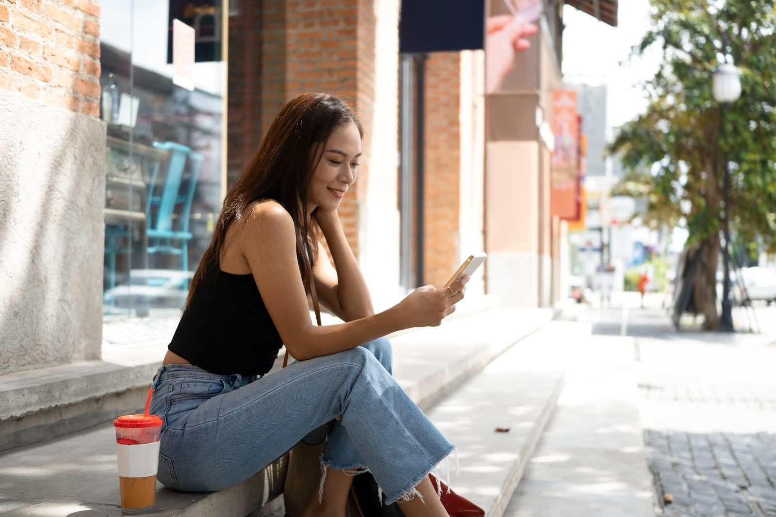 Woman using her phone during a self-guided EMDR session