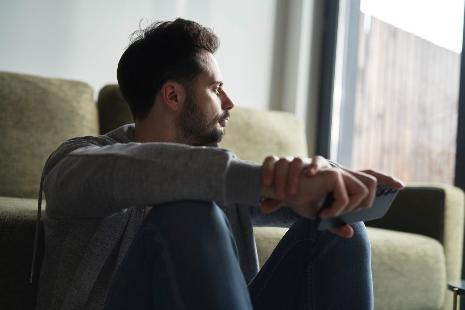 Man sitting at home reflecting on panic-related feelings