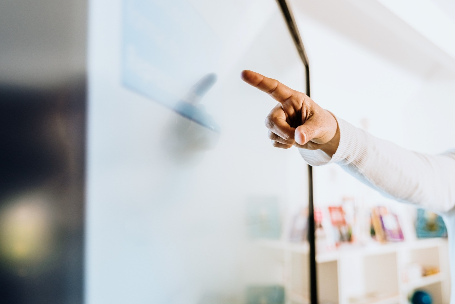 Close-up of a person pointing at a computer screen, illustrating communication and sharing experiences after an EMDR session.