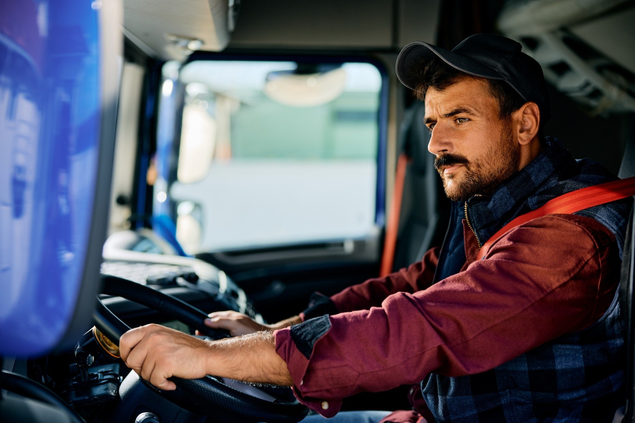 Man driving a truck while looking ahead
