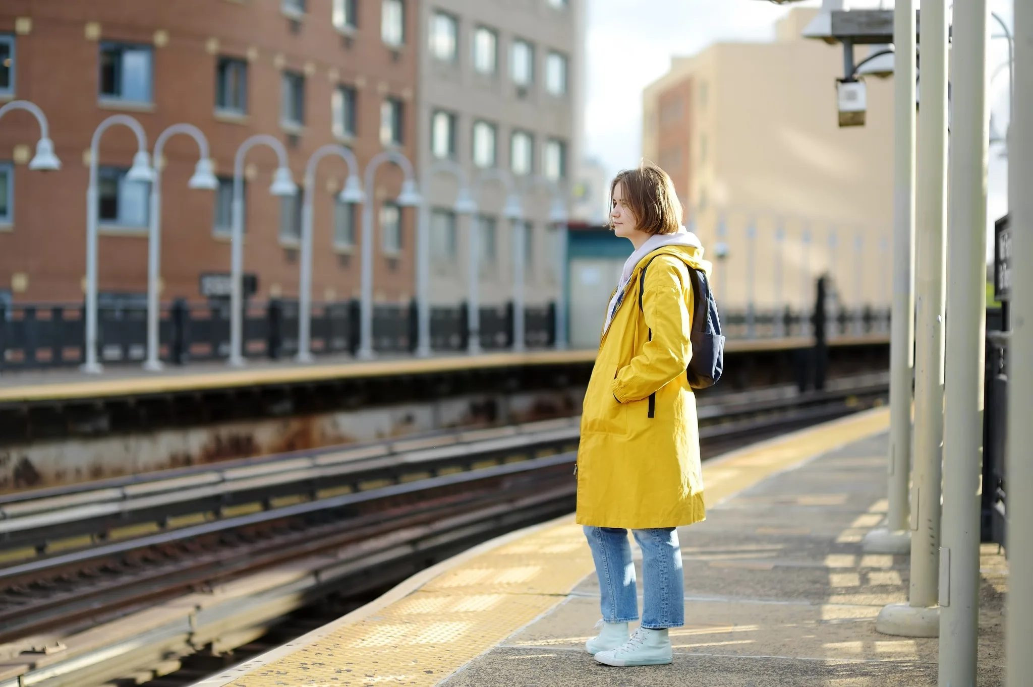 Woman standing on a train platform with luggage, representing fear and phobia-related situations