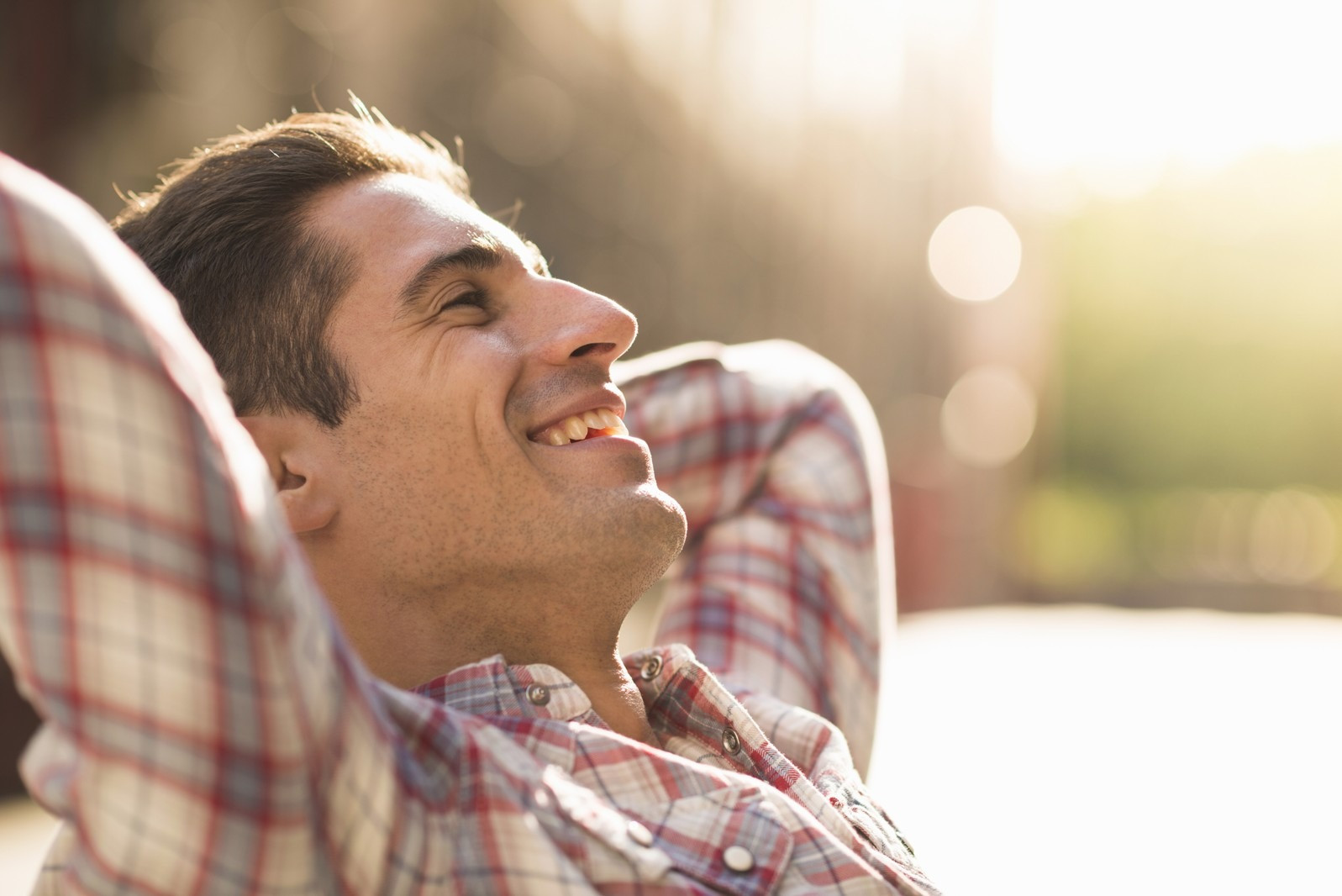 Smiling man relaxing outdoors, representing a positive belief and emotional shift during EMDR.
