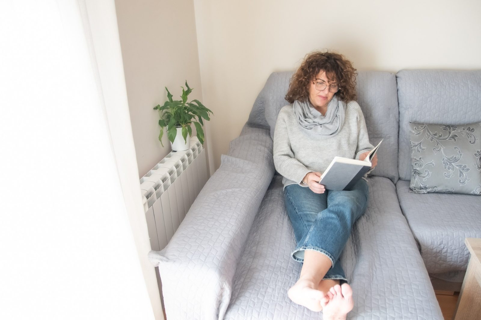 Woman sitting at home reflecting on her emotions