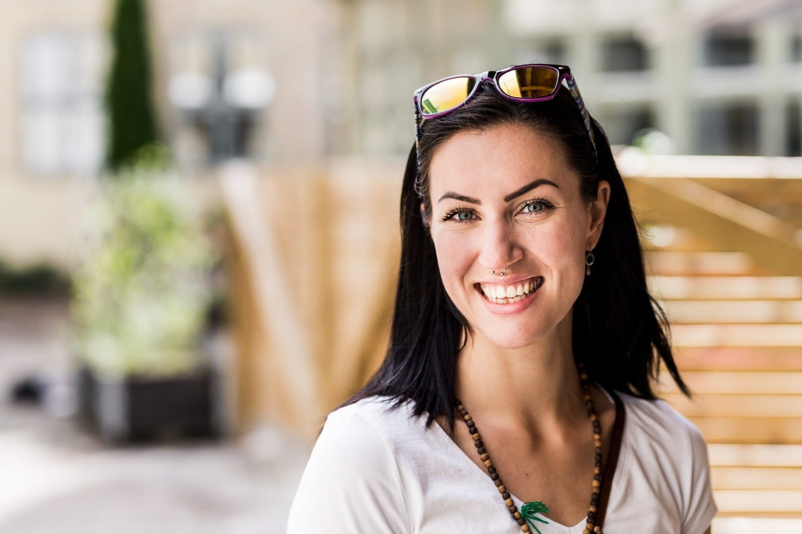 Smiling woman wearing sunglasses on her head outdoors