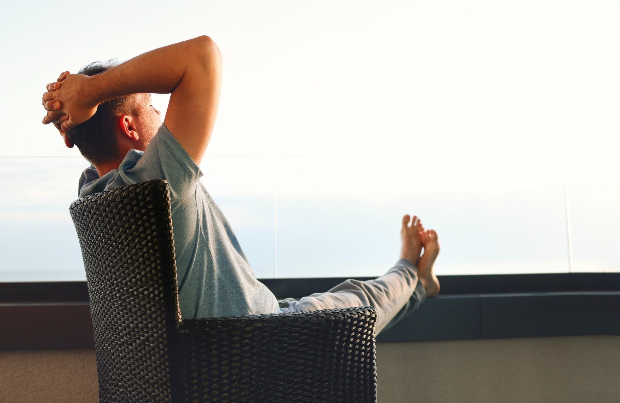 Man relaxing in a chair by a bright window in the morning