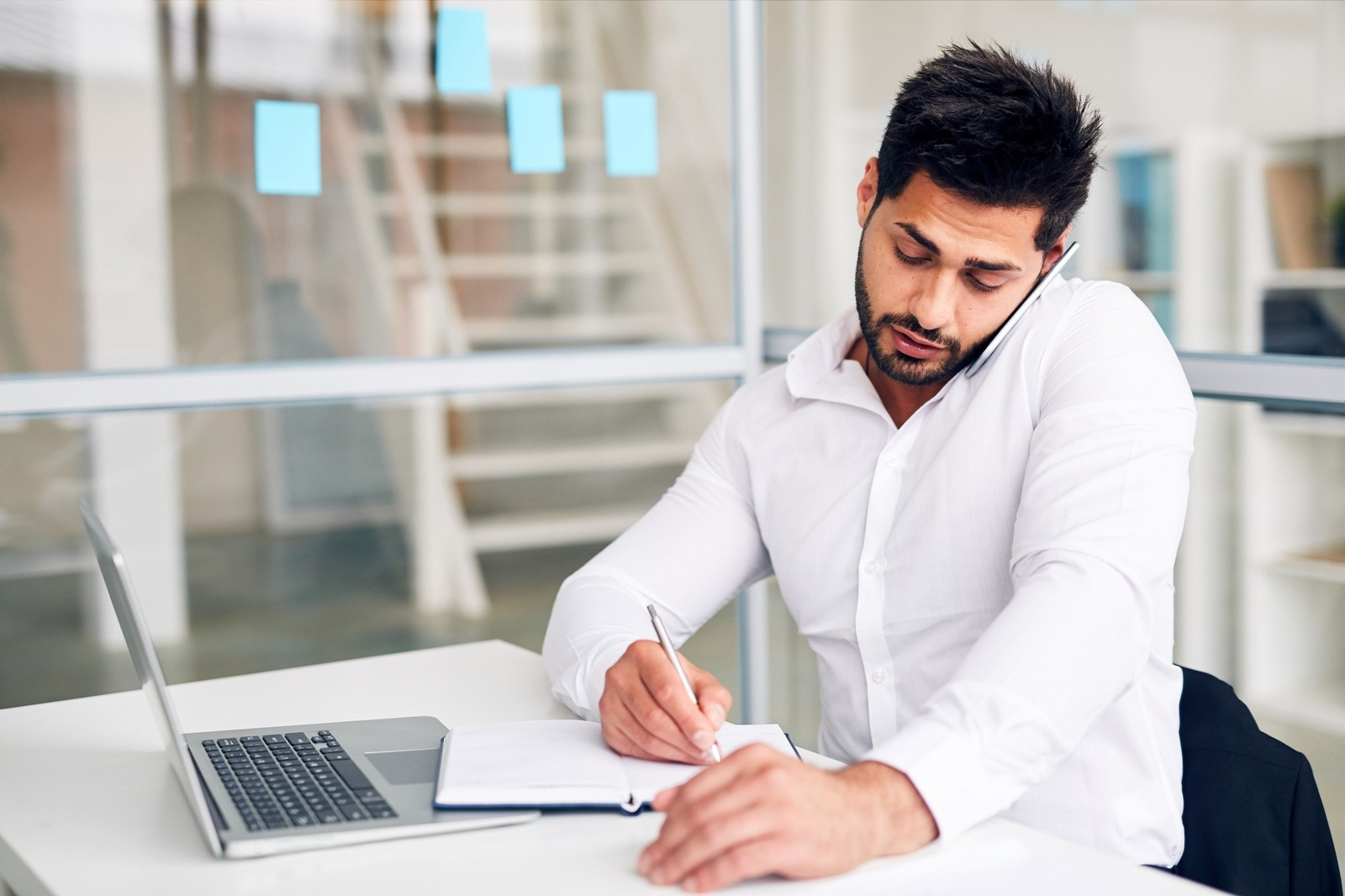 Man writing notes at a desk after an EMDR session