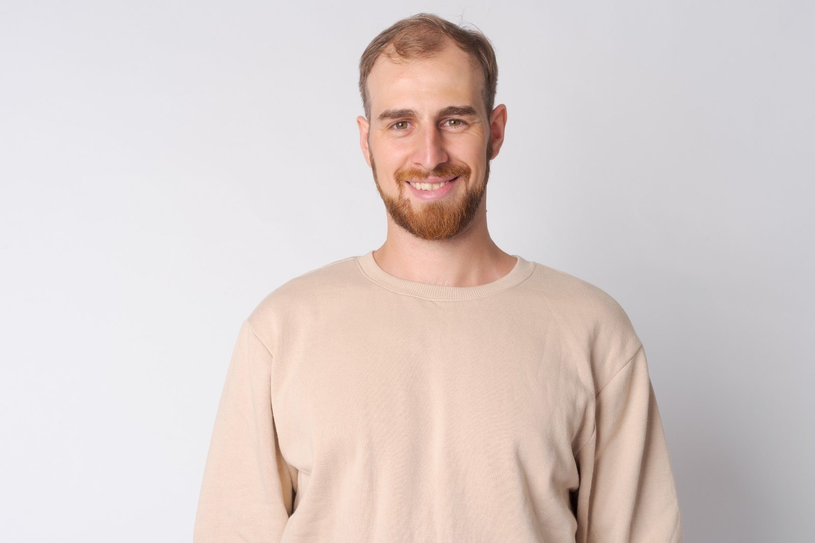 Man smiling calmly while reflecting on his experience