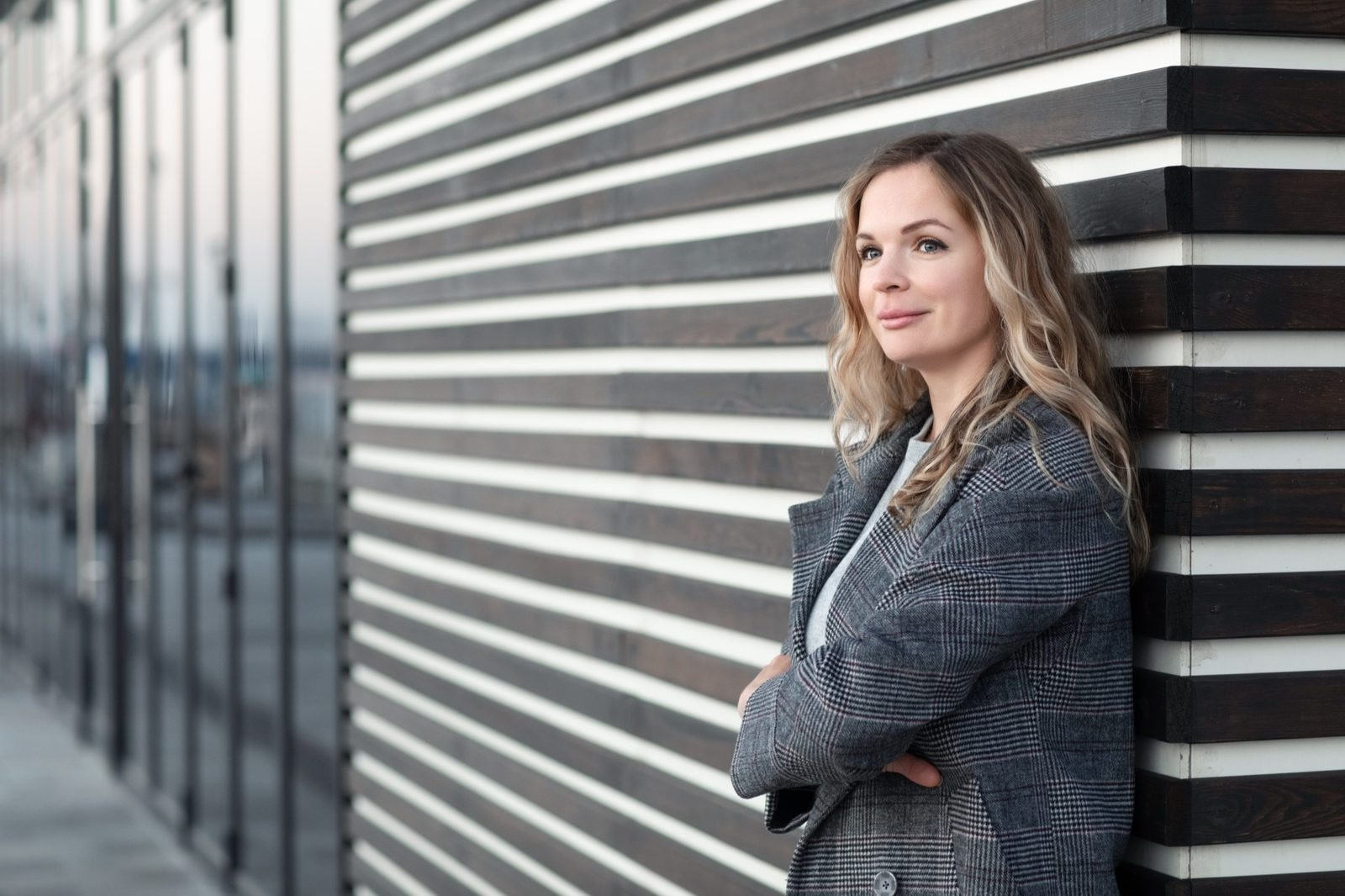 Woman standing outdoors with a calm and confident expression